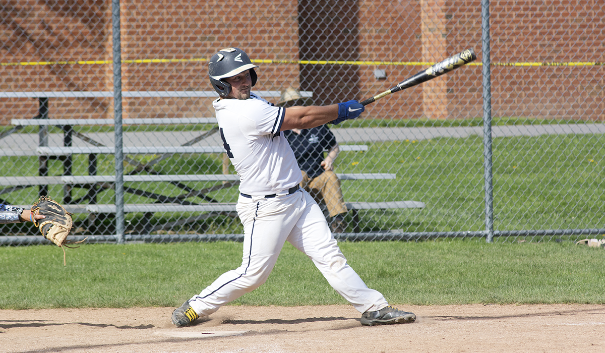 Photo by Earl Kufen: Lions catcher Richard Carey makes contact during the game two win over Mount Aloysius on Tuesday.