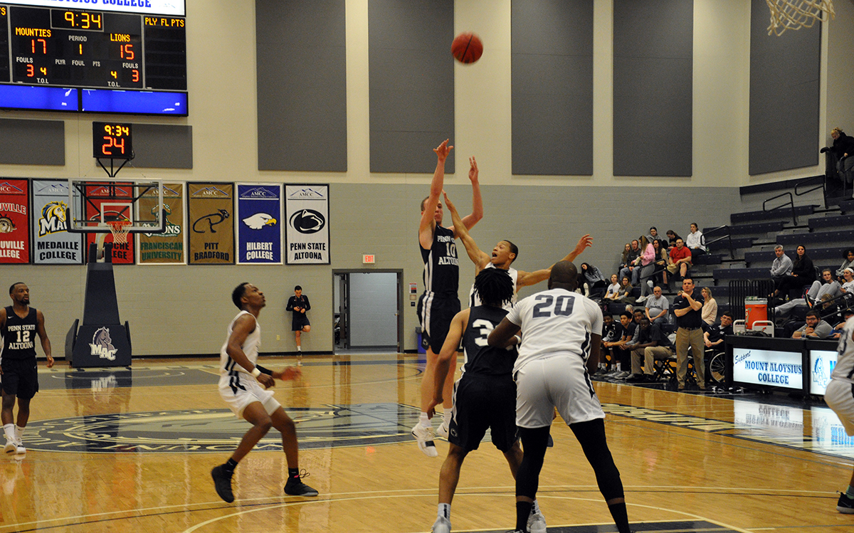 Photo: Senior forward Marshall Higley takes a three-pointer during Wednesday night's loss at Mount Aloysius College.