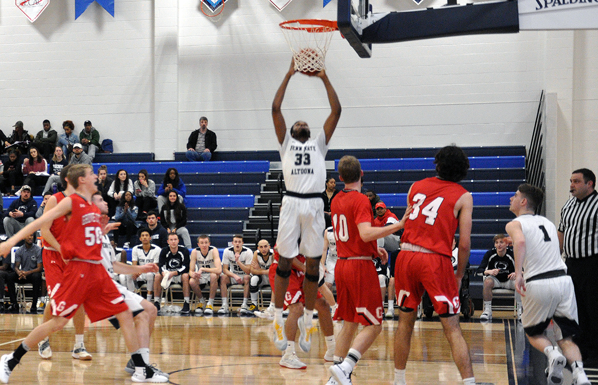 Photo (by Cory Maines): Junior center Cameron Gardner-Nicholson goes up for a dunk during Wednesday night's win over Grove City.