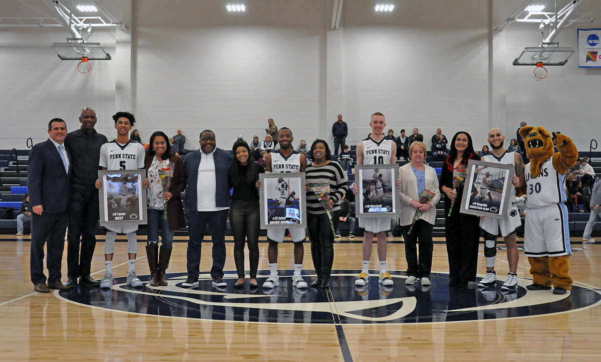Photo: The Lions' four seniors pose with their families for a photo during Saturday's Senior Day ceremony.