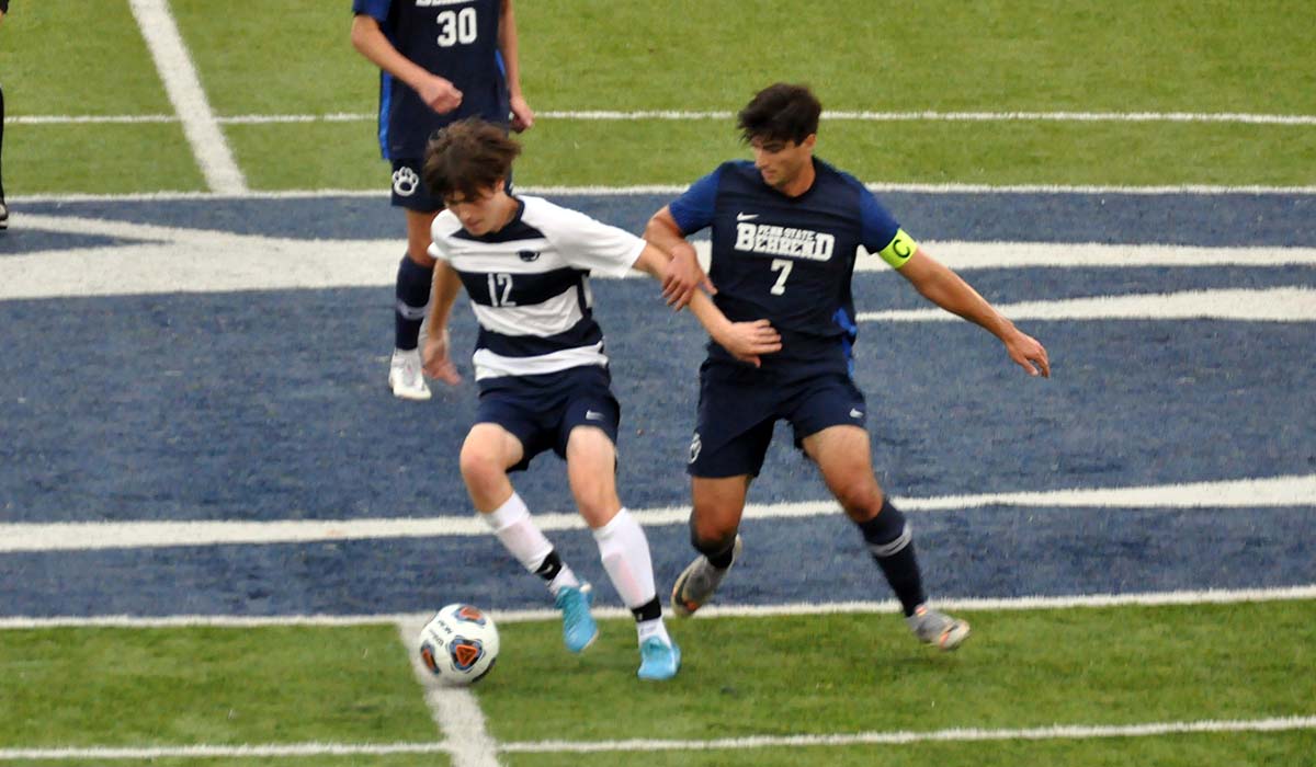 Photo: Freshman Damian Dangler fends off Penn State Behrend's Sean Abraham during Saturday's game.