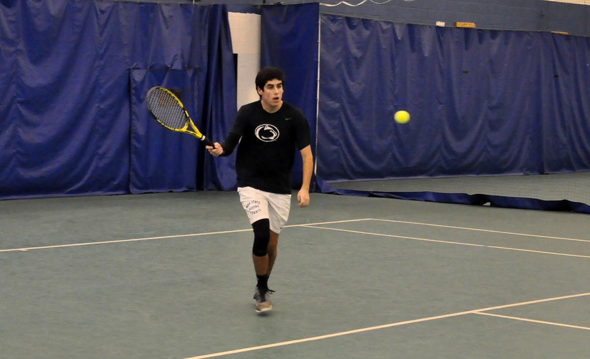 Photo: Jimmy Gillespie comes forward to hit a shot during his No. 1 singles match on Wednesday against Lycoming at The Summit Tennis and Athletic Club.