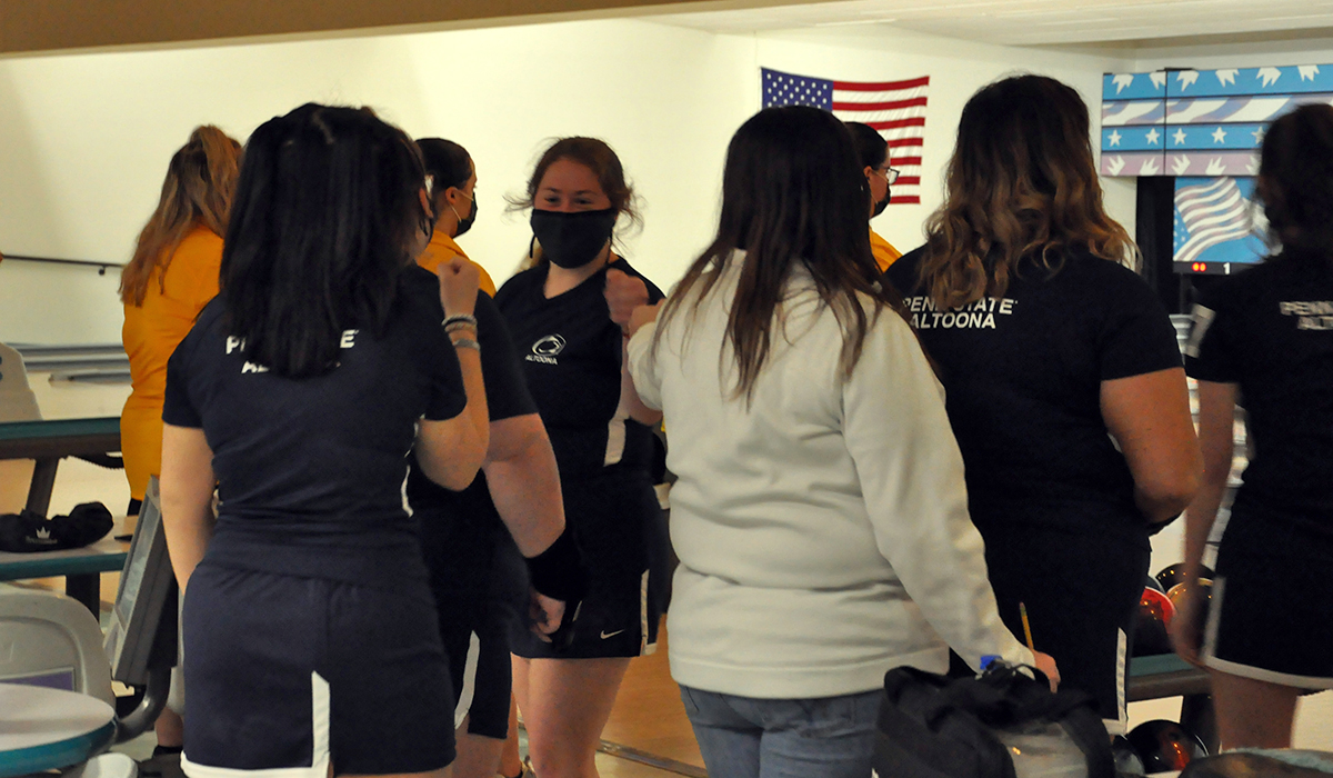 Sophomore Kaitlyn Estright is congratulated by teammates after a roll on Saturday.
